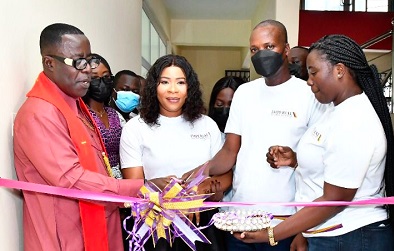 Robert Wugah (2nd right), Managing Director, Imperial General Assurance, being assisted by Grace Kissiedu (middle), Weija Branch Manager, and Apostle Abraham L. Mensah, General  Overseer, Inner Court Family Chapel, to perform the opening of the new branch.